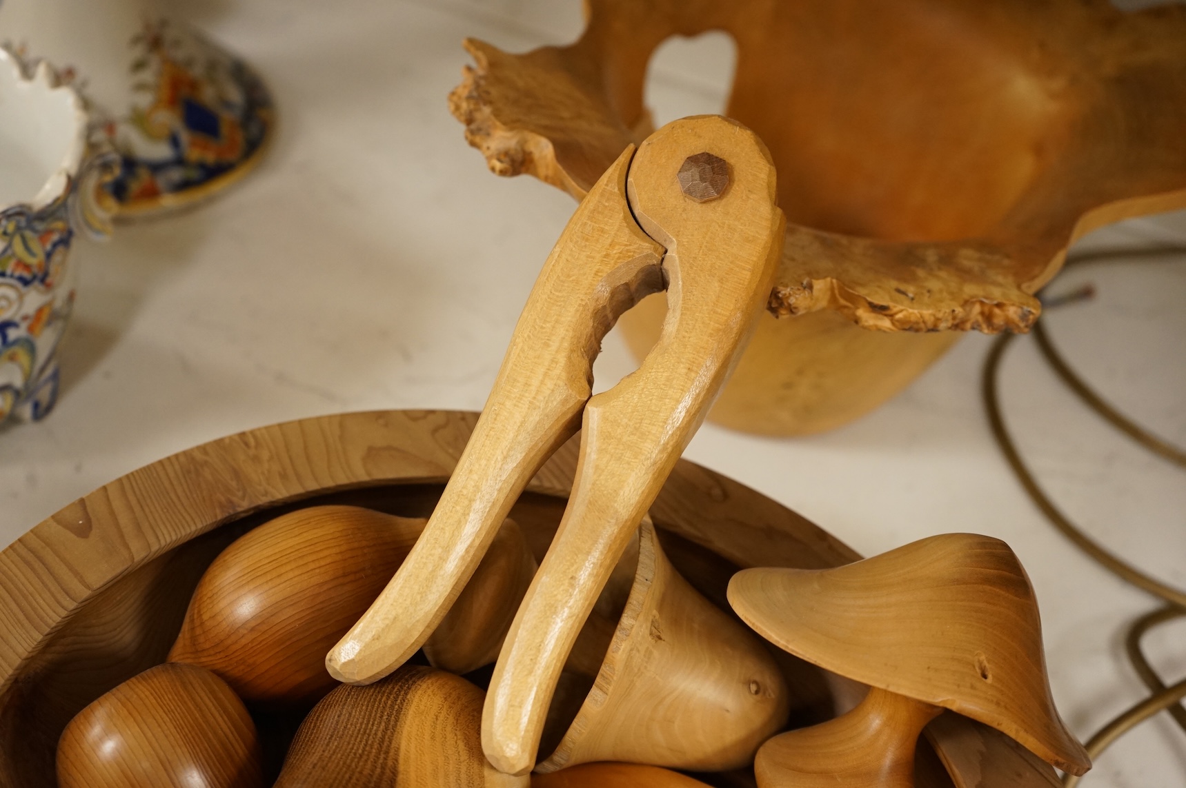 A modern treen yew bowl, a burr wood bowl and various fruit